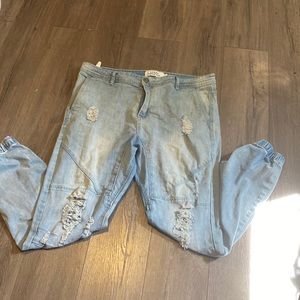 Light blue denim pants with elastic around the ankles